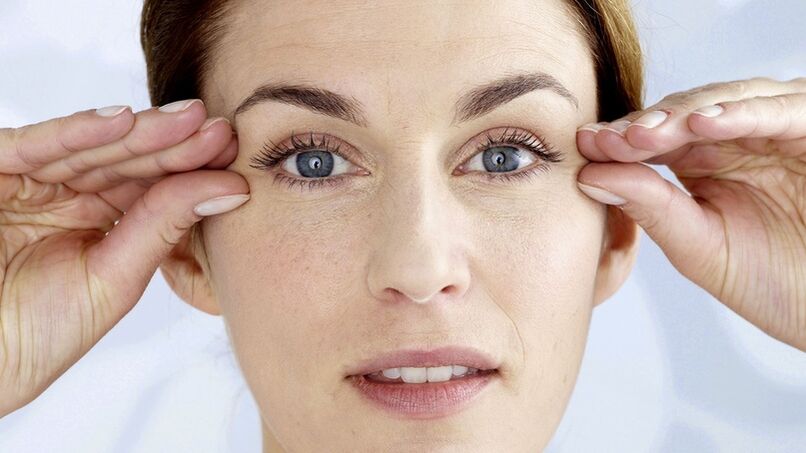 A woman holds her hand near her eyes
